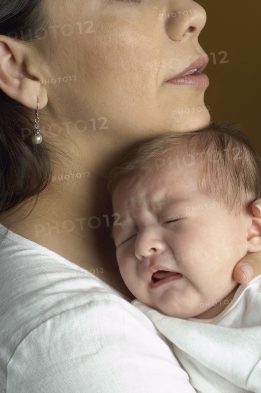 Hispanic mother hugging baby