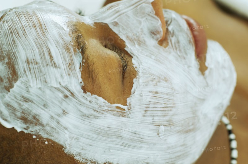 African man receiving spa facial treatment