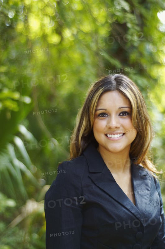 Hispanic businesswoman posing outdoors