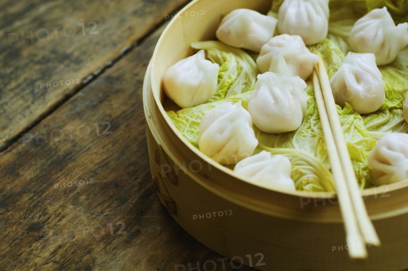 Asian dumpling in steamer with cabbage