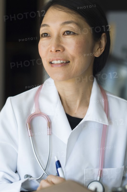 Japanese doctor writing on clipboard