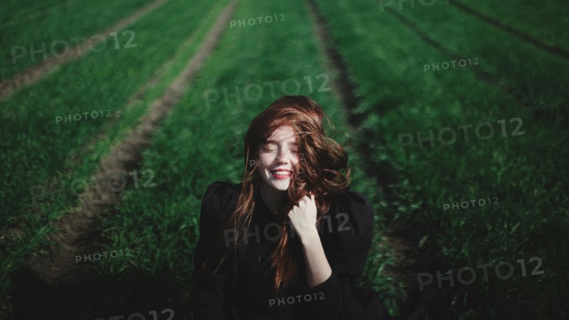 Smiling Caucasian woman in rows of grass