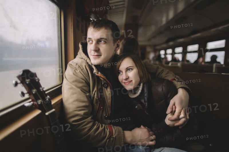Caucasian couple hugging on train