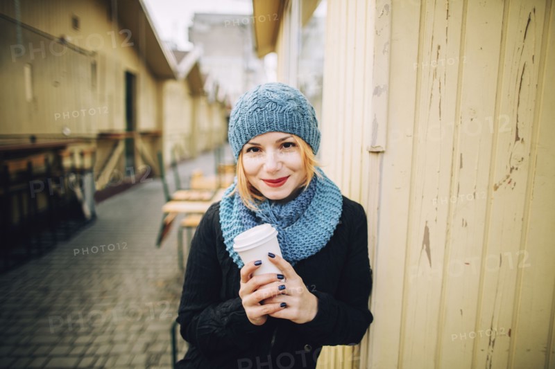 Portrait of smiling Caucasian woman holding coffee cup