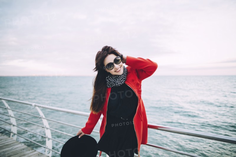 Portrait of smiling Caucasian woman standing on boardwalk