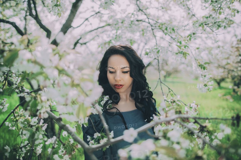 Caucasian woman standing near flowering tree