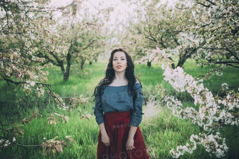 Caucasian woman standing near flowering trees