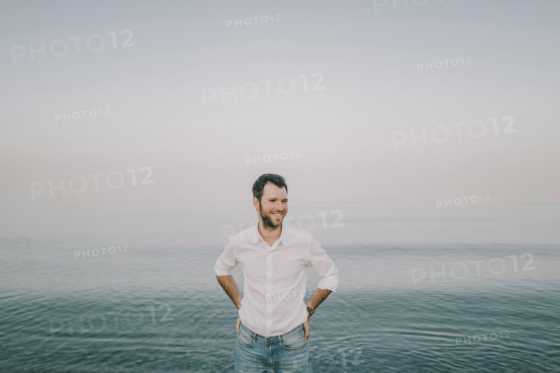 Caucasian man standing near ocean