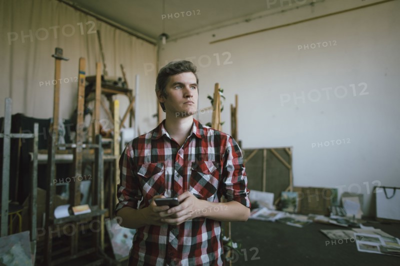 Pensive Caucasian man texting on cell phone