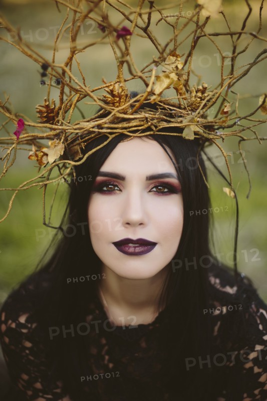 Gothic Caucasian woman wearing crown of branches