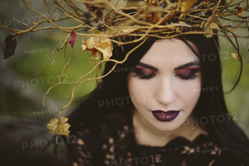 Gothic Caucasian woman wearing crown of branches