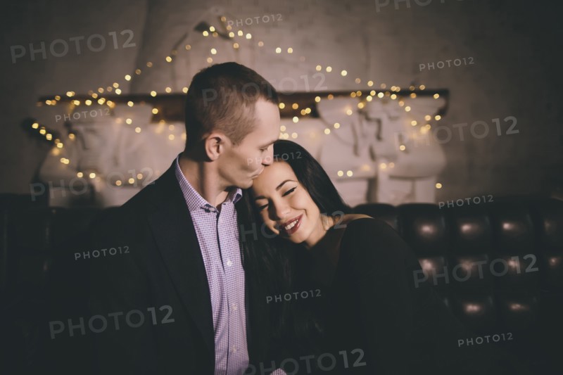 Caucasian man kissing forehead of woman
