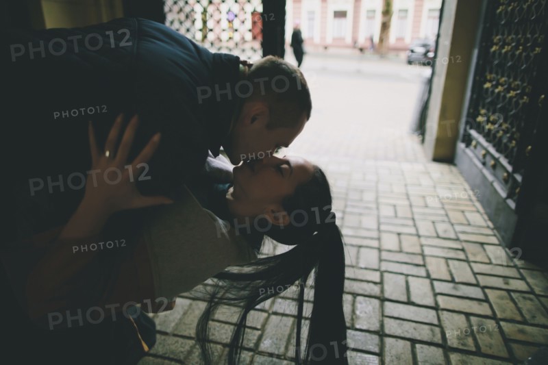 Caucasian man dipping and kissing woman