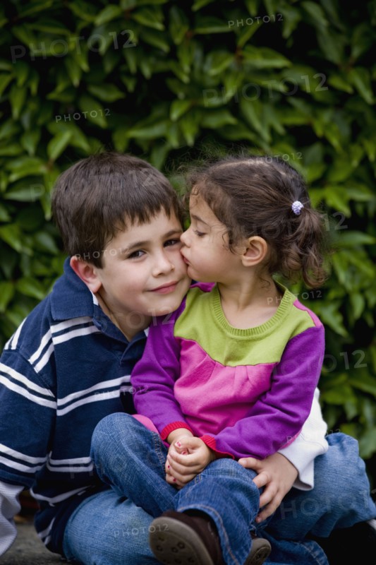 Sister kissing brother
