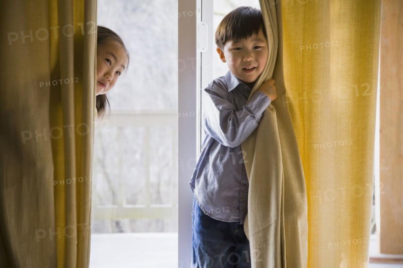 Korean children behind curtains