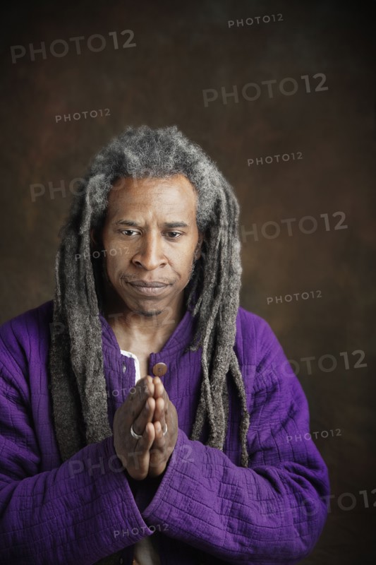 African man with dreadlocks praying