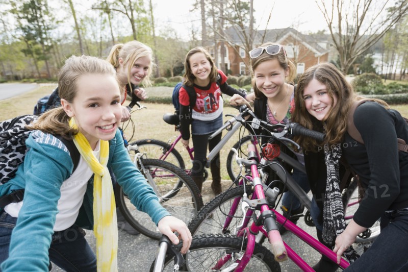 Caucasian friends on bicycles