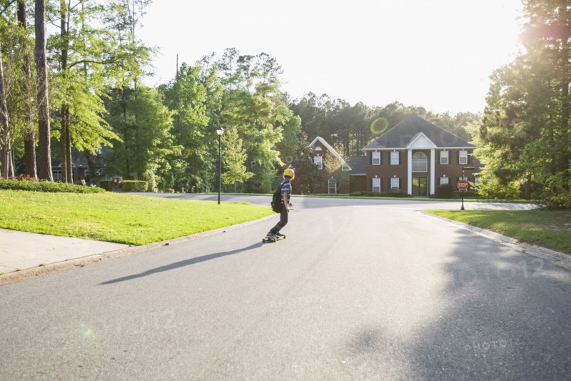 Caucasian boy skateboarding on road