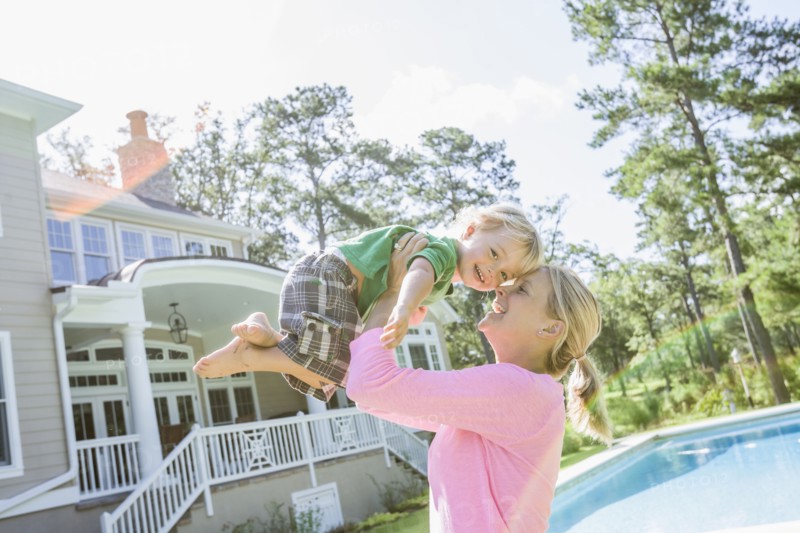 Caucasian mother and son playing in backyard