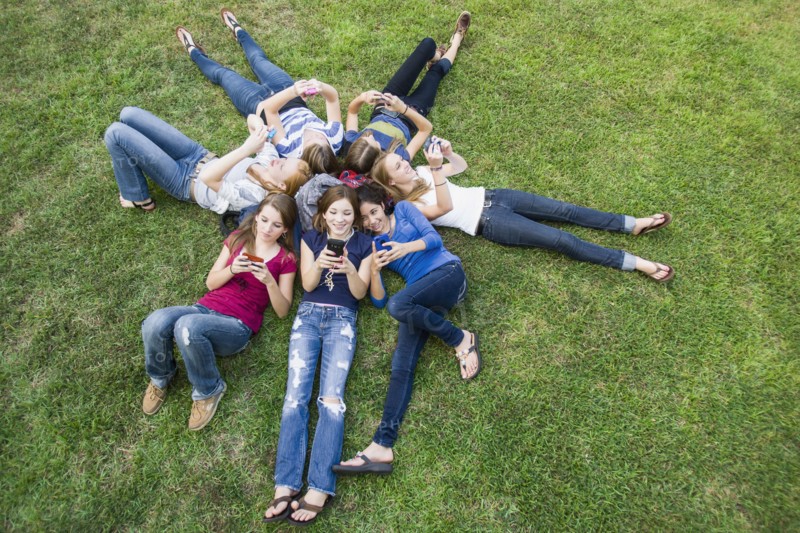 Friends hanging out together on grass