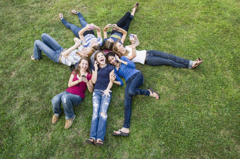 Friends hanging out together on grass