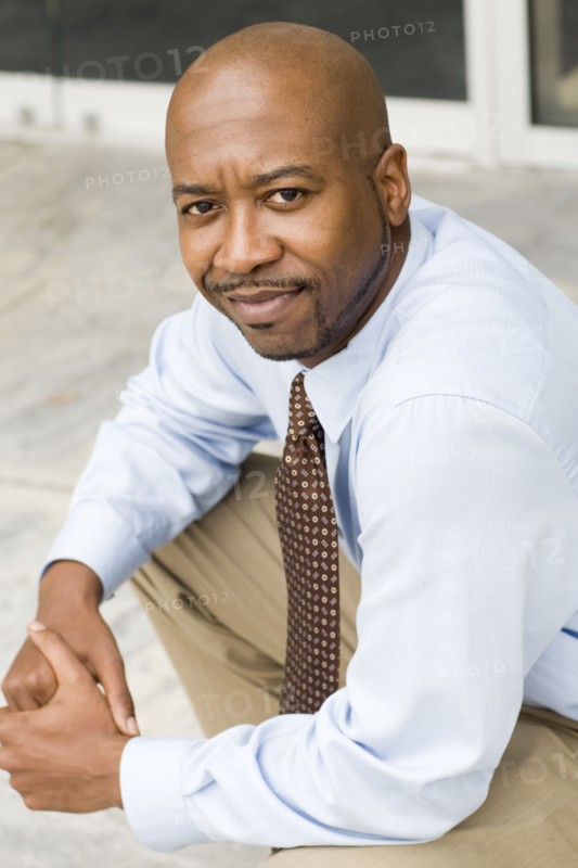 Black businessman sitting outdoors