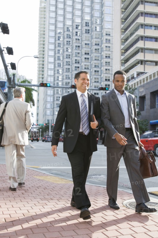 Businessmen walking together on city street