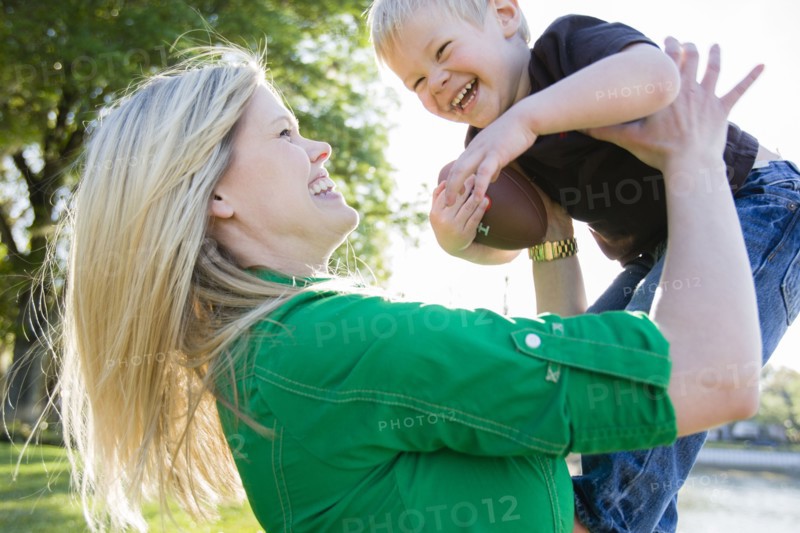 Caucasian woman playing with son