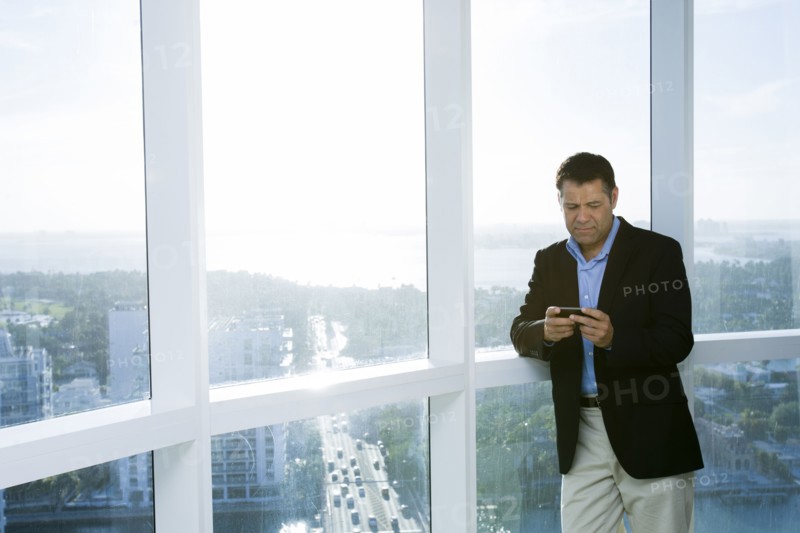 Hispanic businessman using cell phone