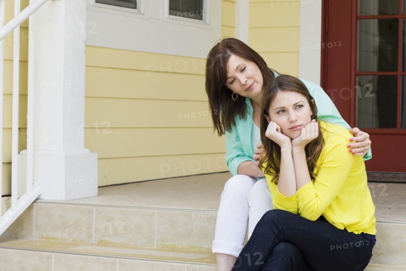Caucasian mother comforting daughter outdoors