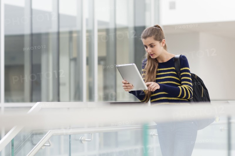 Caucasian student using digital tablet on campus