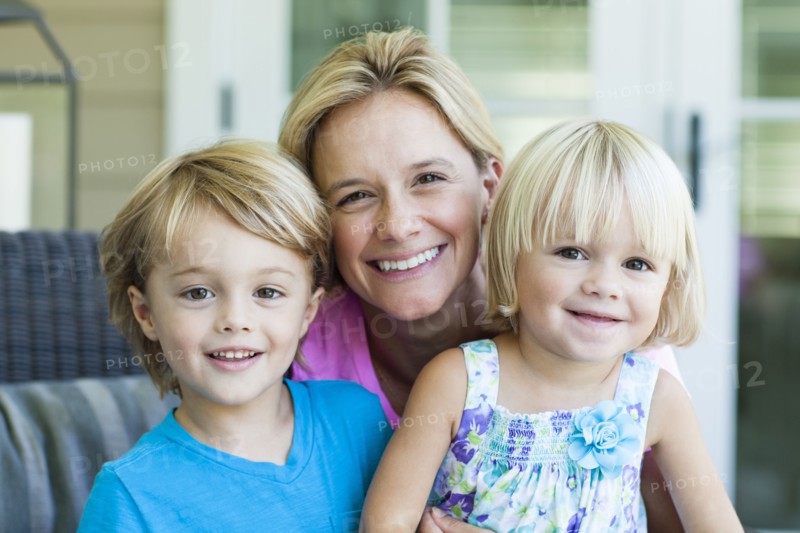 Caucasian mother and children smiling outdoors