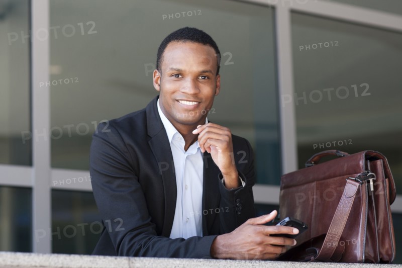 Black businessman using cell phone