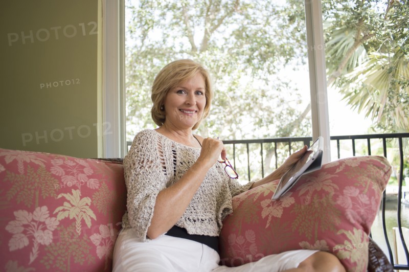 Caucasian woman using digital tablet on sofa
