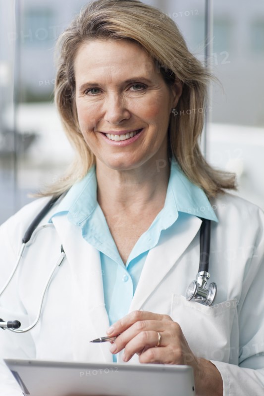 Close up of Caucasian doctor using digital tablet