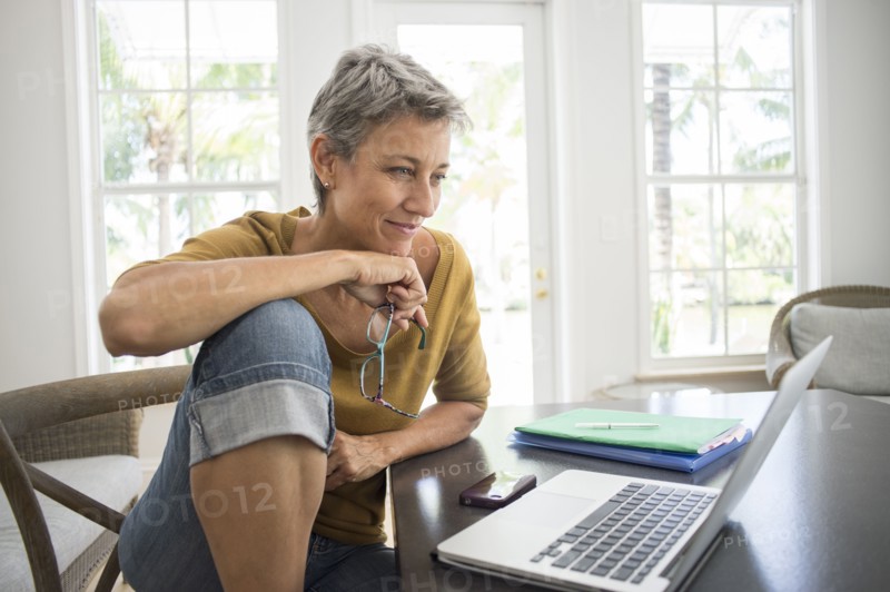 Woman using laptop in living room