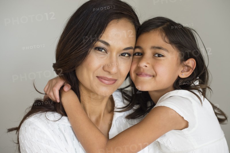 Close up of mother and daughter hugging