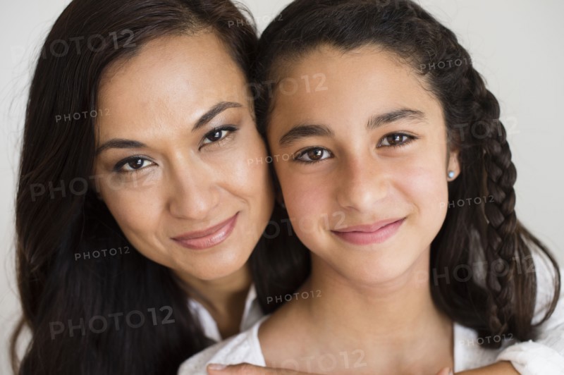 Close up of mother and daughter hugging