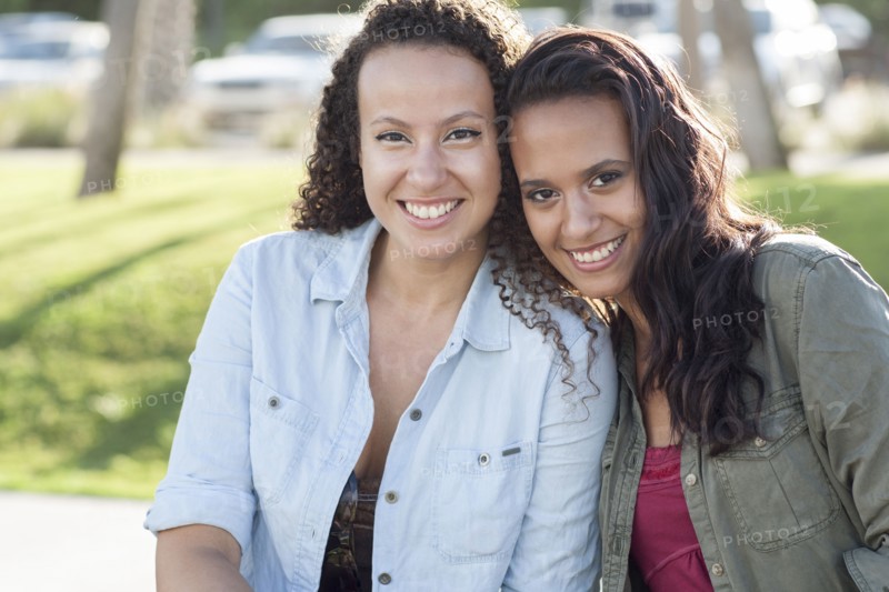 Close up of smiling women hugging in park