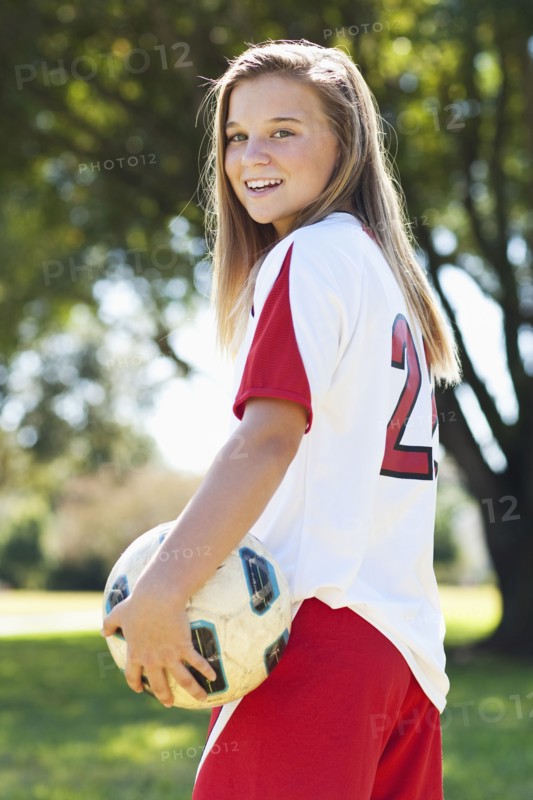 Caucasian soccer player holding ball