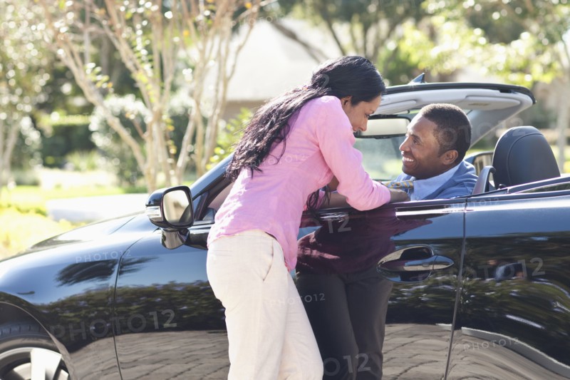 Couple hugging in convertible