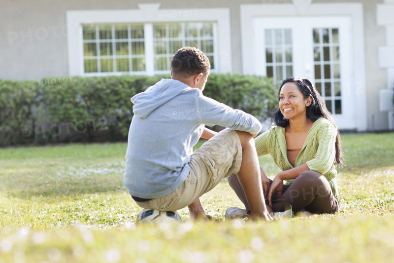Mother and son talking in backyard