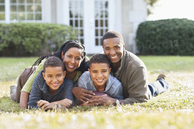 Smiling family playing in backyard