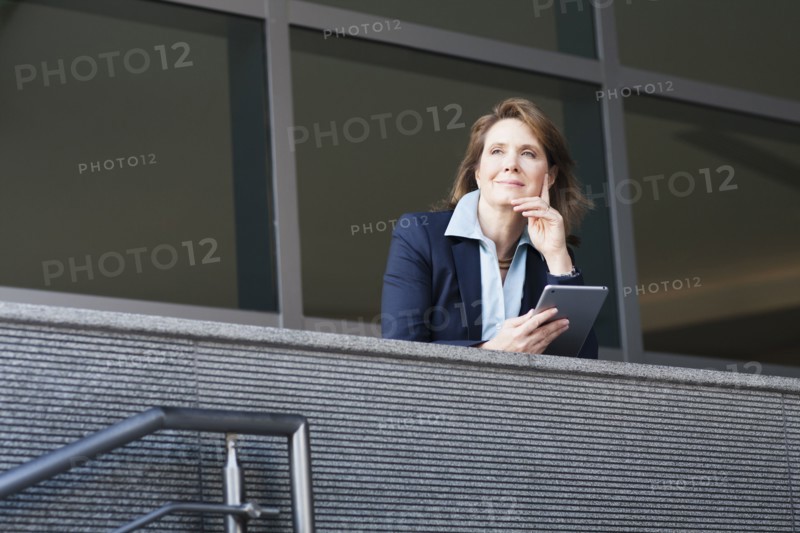 Caucasian businesswoman using digital tablet on balcony