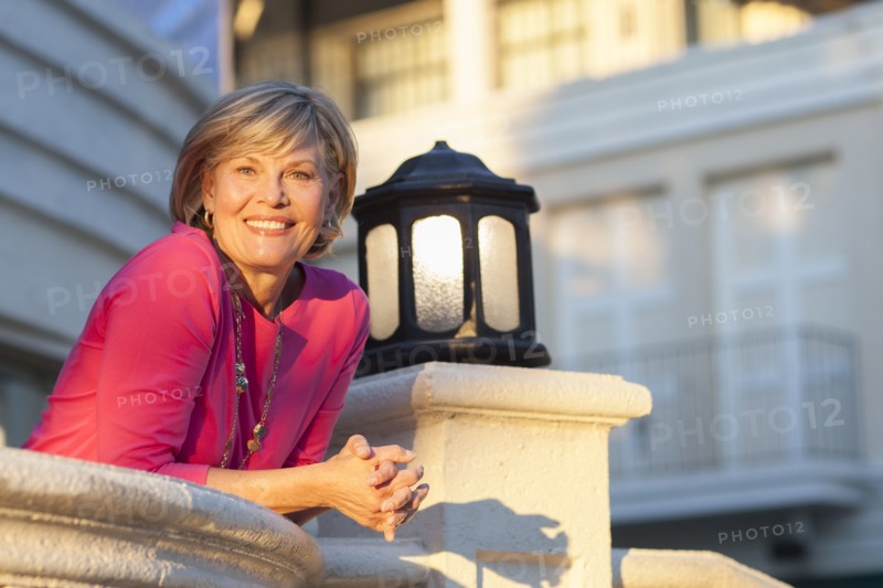 Caucasian woman leaning over balcony