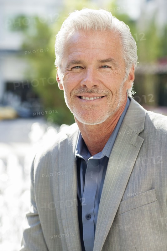 Caucasian businessman smiling in city