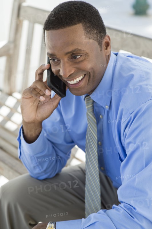 Black businessman talking on cell phone