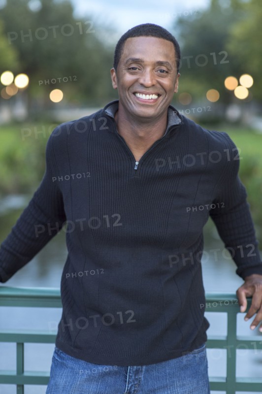 Black man standing on bridge
