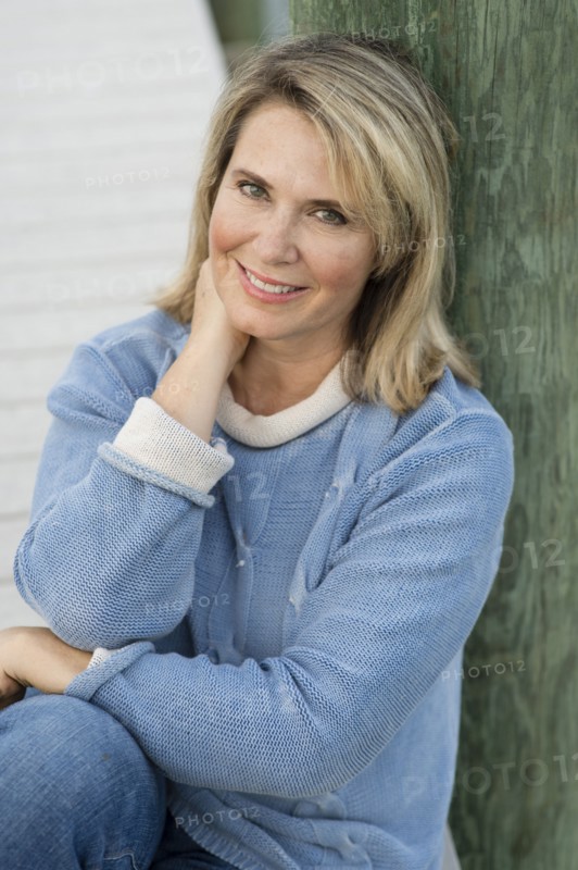 Older Caucasian woman leaning on pier