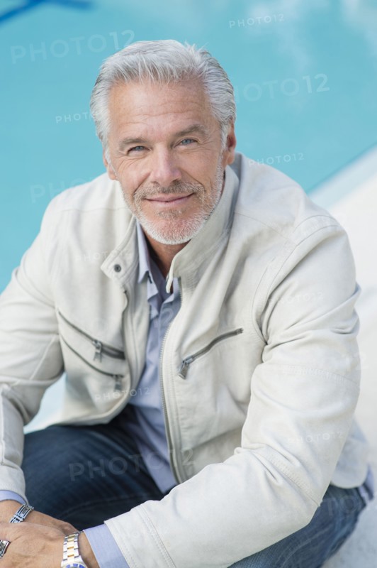 Caucasian man sitting poolside